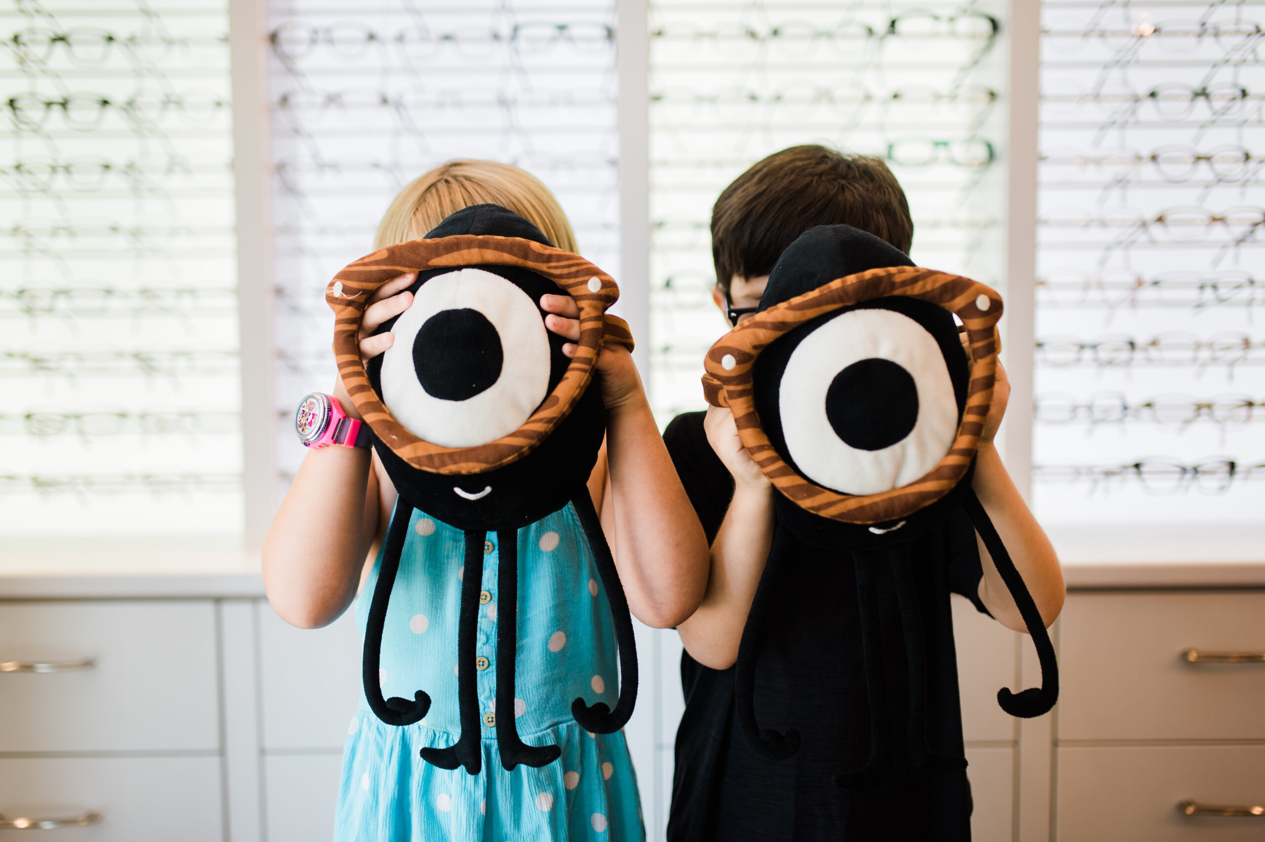 Two kids play as they wait for their kids eye exam in Kamloops at Nicola Eye Care