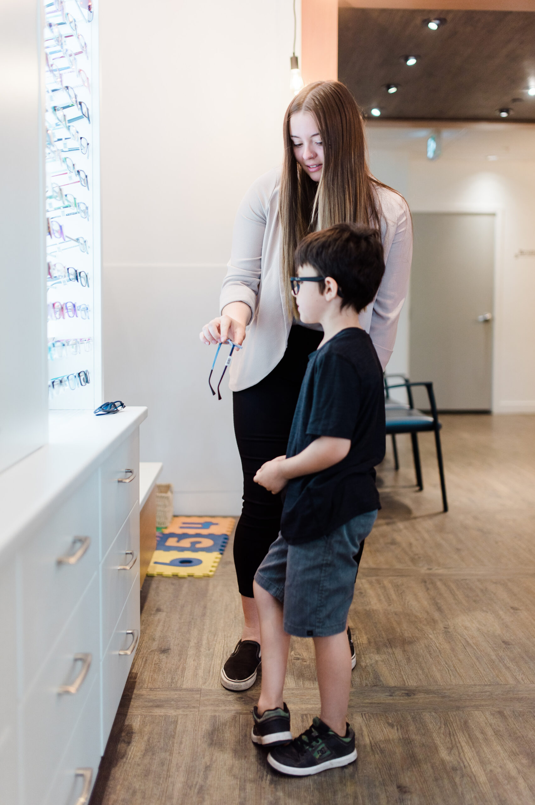 A team member at Nicola Eye Care explores options for a children's eye glasses in their Kamloops location