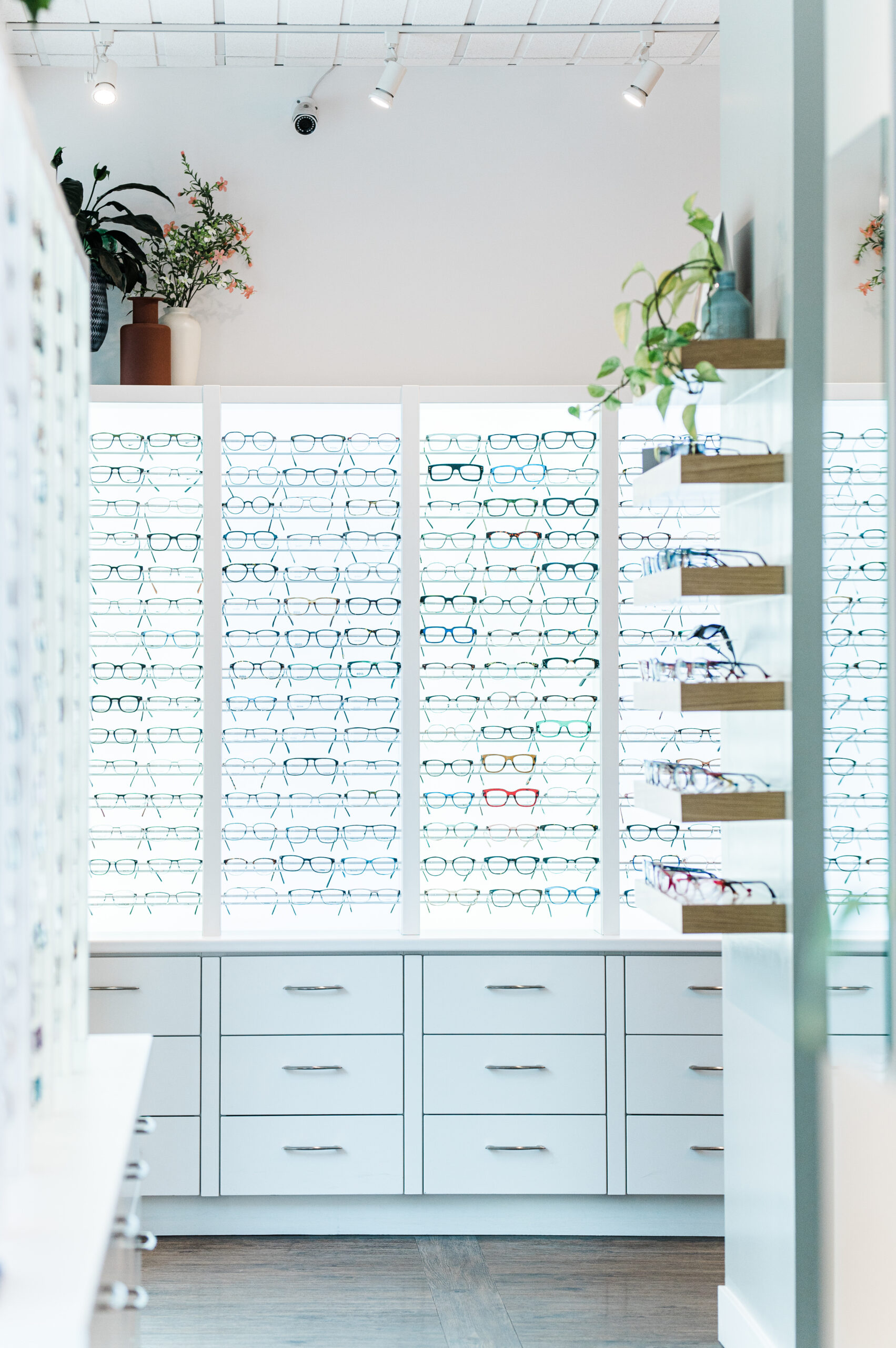 A bright wall displays different styles of glasses to choose from inside Nicola Eye Care