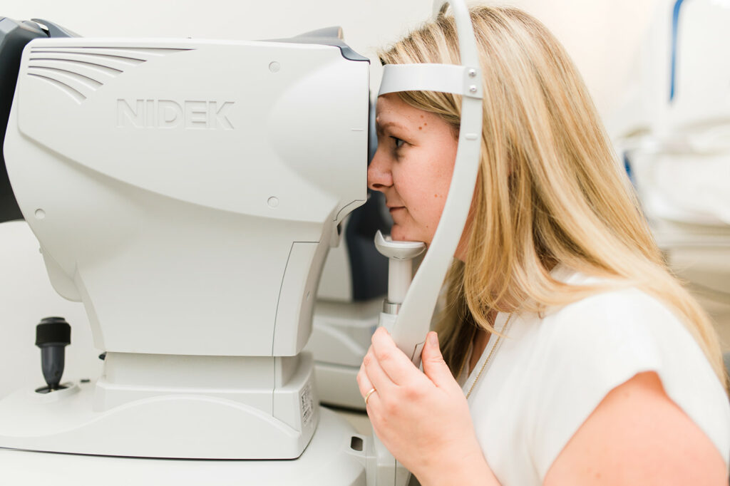 woman gets an eye exam testing her eyesight in kamloops bc clinic