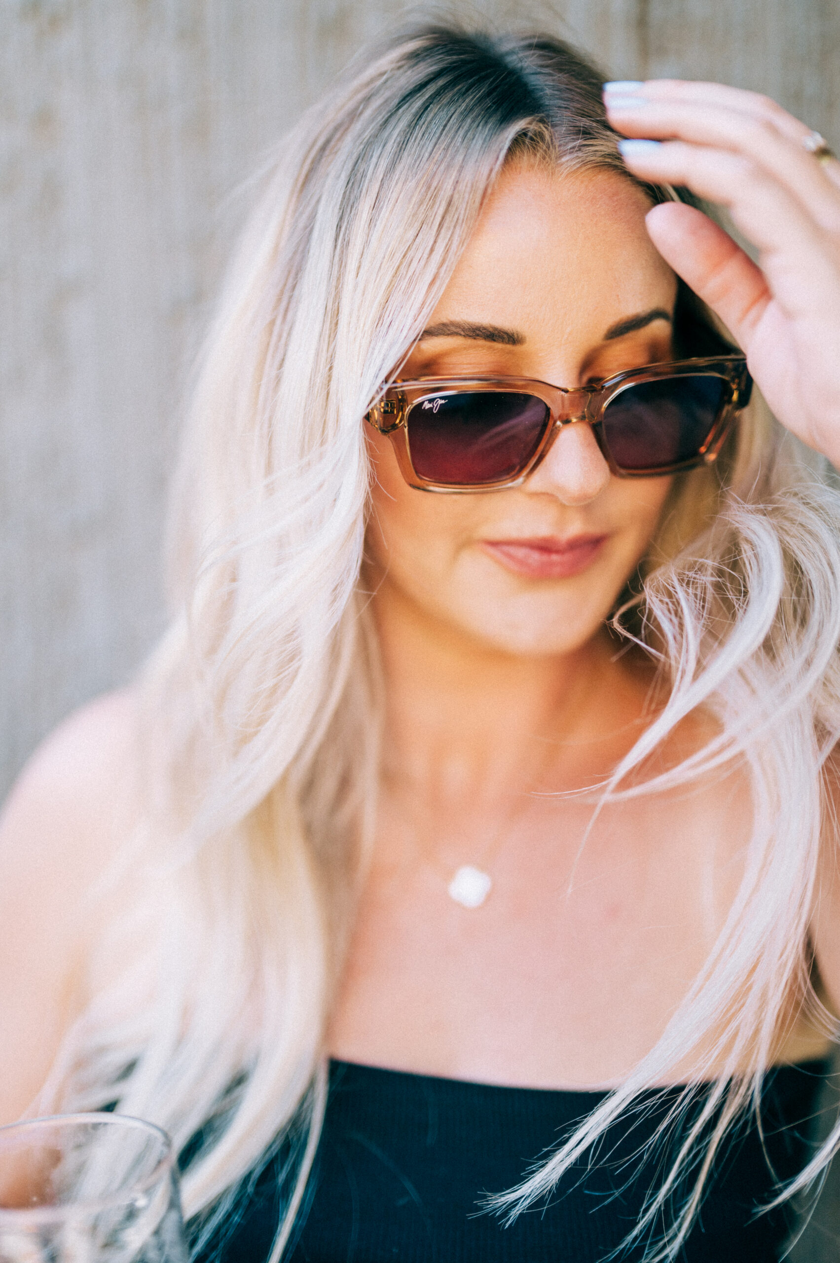 Girl with blonde hair wearing Maui Jim sunglasses.