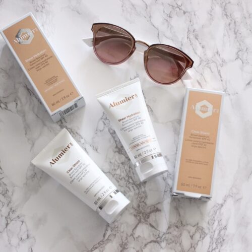 Two bottles of Alumier Sheer Hydration Sunscreen