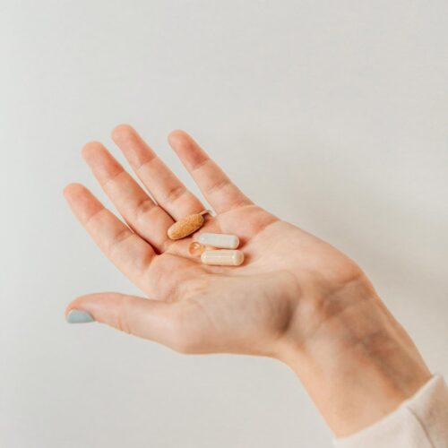 A hand holding supplements designed to support eye health.
