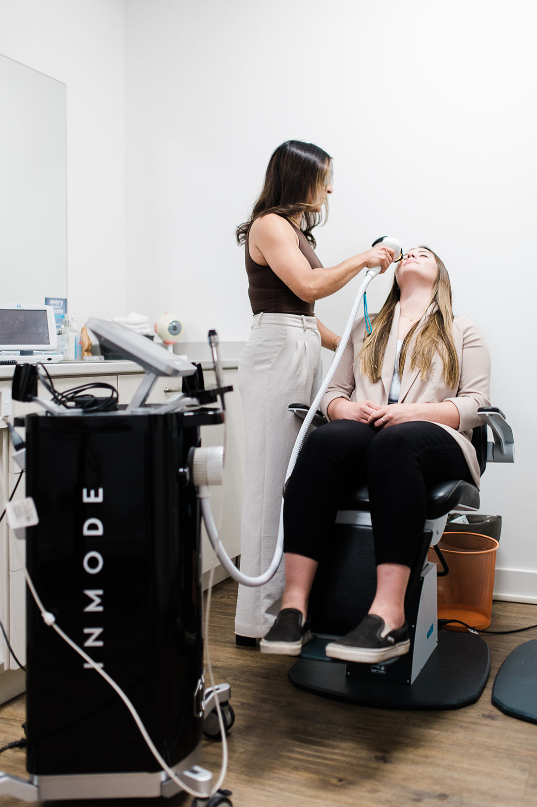 Wide shot of a patient receiving an IPL dry eye treatment at Nicola Eye Care with the treatment device visible beside the chair.
